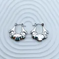 Detailed macro view of silver fan-shaped stainless steel hoop earrings for women - 18K Gold / Silver Fan Stripe (091)