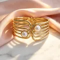 Close-up of a vintage gold cuff bracelet featuring double pearls and a multi-wire design - Multi-layer Hollow Artificial Pearl