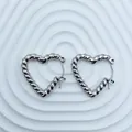 Detail view of elegant silver twisted heart hoop earrings in polished stainless steel. - 18K Gold / Silver Twisted Rope Heart (095)