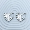 Macro view of silver heart-shaped stainless steel earrings with a radiant pleated texture. - 18K Gold / Silver Pleated Heart (090)