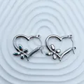 Close-up detail of silver stainless steel heart-shaped hoop earrings with butterfly accents. - 18K Gold / Silver Butterfly Heart (093)