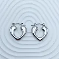 Silver heart-shaped hoop earrings with polished stainless steel finish on textured background - 18K Gold / Silver Smooth Full Heart (103)