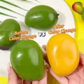 Close-up of color-changing mango squeeze toy transitioning from green to yellow - Color Changing Mango