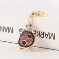 Sparkling purple rhinestone turtle keychain with polished gold-toned metal hardware - Lang Purple Jade