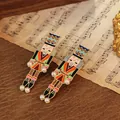 Festive nutcracker soldier drop earrings featuring colorful enamel and pearl accents - Orange Green Red and Blue Style (E31948)