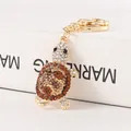 Sparkling turtle keychain decorated with brown and white rhinestones in gold finish - Amber Brown Rock