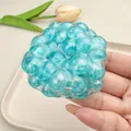 Macro detail of blue pearlescent squishy stress ball toy held in hand for relief - Blue Pearl Handmade Ball