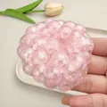 Close-up macro detail of a shimmering pink pearl bubble fidget toy for stress relief - Pink Pearl Handmade Ball