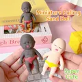 Detailed view of mini baby squeeze toys in black and white skin tones for stress relief - 12cm Pieces / White