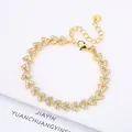 Elegant 18K gold plated heart link bracelet pavé set with sparkling clear zircons. - Style 19 (Model 19)
