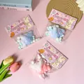 Close-up detail of cute simulation croissant squeeze toys with pastel colored packaging - Squishy Toy / Simulation Croissant Style (Gradient Glitter)