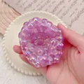 Macro detail of a purple bubble-textured squishy stress relief toy held in hand - Large Purple Boom Beads