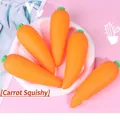 Detailed view of multiple orange carrot squeeze toys for stress relief on a pink background - Expressionless Carrot
