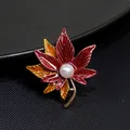 Elegant red and orange enamel maple leaf brooch featuring a central pearl accent - Two-Tone Maple Leaf Style (XZ098)