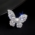Elegant rhinestone butterfly brooch with a large central pearl detail - Crystal Butterfly Style (XZ212)