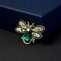 Elegant bee brooch featuring a large green crystal and clear rhinestones on gold base. - Green Emerald Bee Style (XZ249)