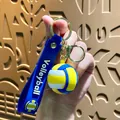 Vibrant blue and yellow volleyball keychain with a soft silicone strap for sports fans - Volleyball