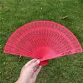 Elegant classical red hollowed wooden folding fan for weddings and bridal dance props - Red