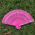 Elegant pink hollow-out folding wooden fan with intricate classical patterns for weddings - Rose Red
