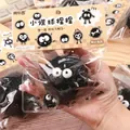 Macro view of a cute black Soot Sprite squishy stress relief toy in its original packaging - Squeeze Coal Briquettes [pvc Bag]