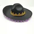 Close-up of black Mexican party hat with gold lace and purple pom-poms decoration. - Purple Fur Ball