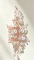 Macro detail of handmade bridal hair comb featuring delicate pearls and crystal leaf patterns - Rose Gold