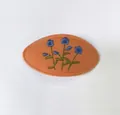 Oval embroidered fabric BB hair clip with blue flower pattern on orange base. - Single Piece / Warm Orange