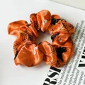 Vibrant orange Halloween scrunchie featuring black spider web and bat printed designs - Orange Ghost