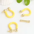 Macro view of copper U-shaped horseshoe clasp with yellow enamel for DIY jewelry accessories - Yellow