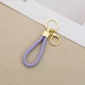 Hand-woven purple braided leather keychain with elegant gold-tone hardware clasp - Generation 1 Round Dragon Woven Buckle (Light Gold) / Purple