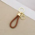 Handmade brown braided leather rope keychain with elegant gold hardware for car keys - Generation 1 Round Dragon Woven Buckle (Light Gold) / Brown