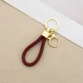 Elegant maroon braided leather cord keychain with polished gold-tone metal clasp loop - Generation 1 Round Dragon Woven Buckle (Light Gold) / Burgundy