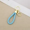 Handmade sky blue braided leather keychain with gold-plated metal hardware - Generation 1 Round Dragon Woven Buckle (Light Gold) / Blue