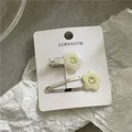 Set of two elegant cream flower hair clips displayed on a white card, Korean style design - Creamy Yellow Flower Hair Clip Set (J300-B151) / Beige