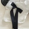 Elegant black satin ribbon bow hair clip with long tails and scalloped edges. - Wavy Edge Ribbon Bow Hair Clip (B53) / Black