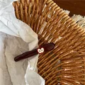Charming dark red wavy duckbill hair clip with an apple accent in a woven basket - White Apple Decorative Duckbill Clip (JX-B197) / White