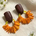 Vintage style earrings with dark wood studs and orange beaded shell drops on cream fabric. - 2607095 Orange Patchwork Wood Earrings