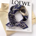 Elegant navy blue mulberry silk square scarf with vintage patterns displayed on a LOEWE magazine - 17201-tibetan Blue / 53*53cm