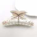 Detailed macro shot of marble acetate hair claw clip with pink rhinestone starfish. - Mermaid White (Coffee Rhinestone)
