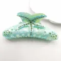 Detailed view of starfish rhinestone and marble texture on acetic hair claw clip - Mint Green (Green Rhinestone)