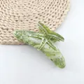 Detailed view of a green marble acetate hair claw clip with a rhinestone starfish motif. - Seaweed Green (Green Rhinestone)