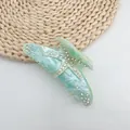 Macro view of a starfish hair claw clip with marble texture and sparkly rhinestones. - Mint Green (White Rhinestone)