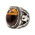 Vintage stainless steel ring featuring a tiger eye gemstone and intricate skull motifs - Tiger's Eye