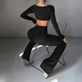 Chic black Y2K style yoga set featuring long sleeve crop top and flared slim fit leggings - Black / XS
