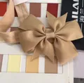 Tan grosgrain ribbon fishtail bow headband for babies on a color swatch background - Fishtail Bow Style (835)