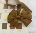 Golden brown grosgrain ribbon bow headband for babies shown on a color swatch card - Fishtail Bow Style (846)