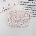 Detail view of a quilted floral mini pouch with a secure flap button and zip closure. - Light Pink Small Flower