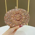 Luxury rhinestone sunflower evening clutch bag with pink crystals held by hand - Champagne