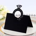 Elegant black laser-cut diamond ring shaped wedding place card displayed on a plate - Black Khaki