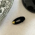 Elegant black velvet oval hair clip featuring a vintage gold heart charm for women - Gold Heart Decor Hair Clip / Black